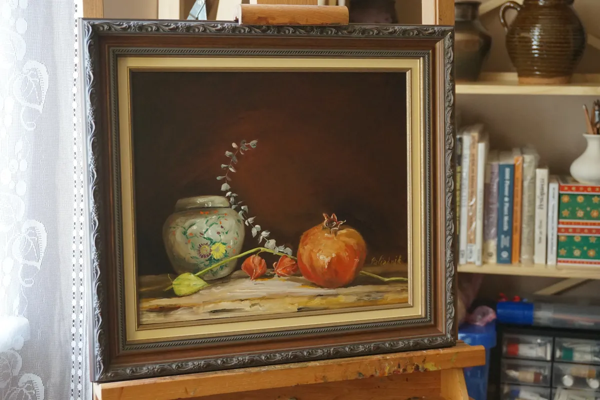 Framed still life with pomegranate and vase